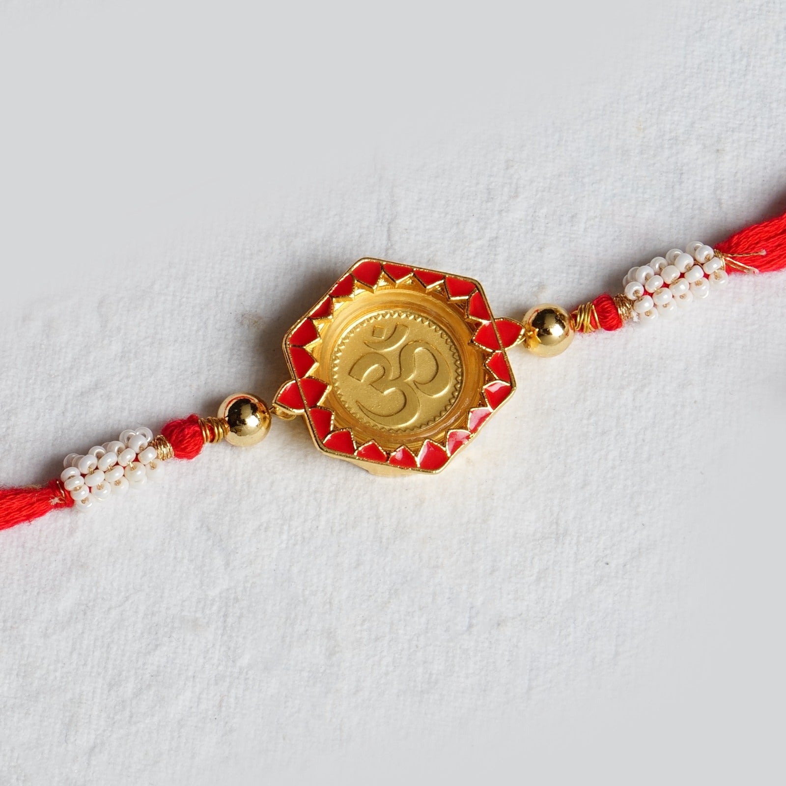 Om Rakhi in 24K Gold: A Sacred Symbol of Protection and Purity